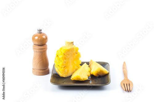 slices and peeled pineapple fruit on white