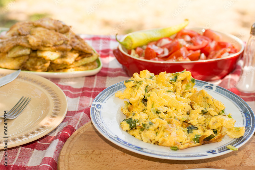 Served lunch with tomato salad and fried zucchini