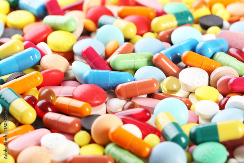 Different colorful pills background