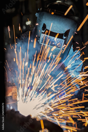 Industrial Worker at the factory welding closeup 