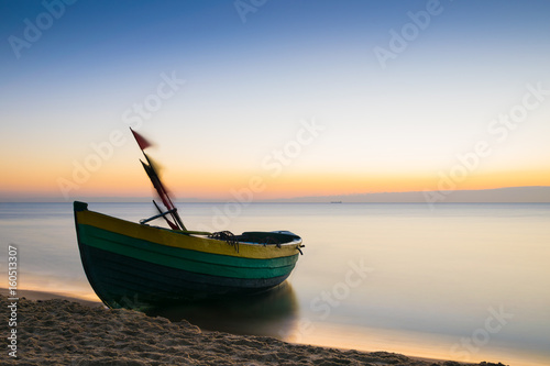 Fishing boat on the Baltic shore at dawn. Long exposure. Europe, Poland.