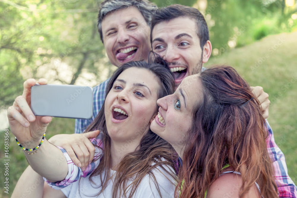 Happy group of young people takes a selfie