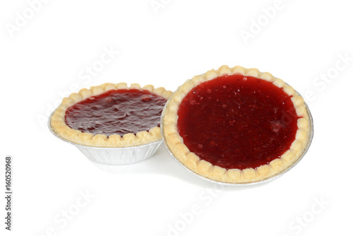 two strawberry tarts in foil cups