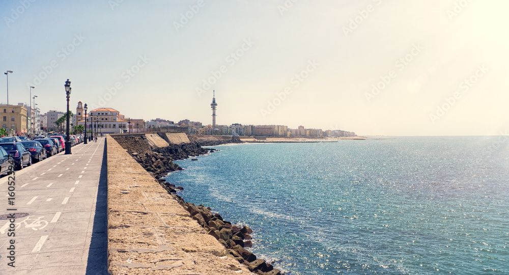 The waterfront of Cadiz city in Spain with a view of the boardwalk along the sea in Sunny day. The horizontal frame.