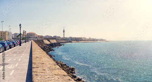 The waterfront of Cadiz city in Spain with a view of the boardwalk along the sea in Sunny day. The horizontal frame. photo
