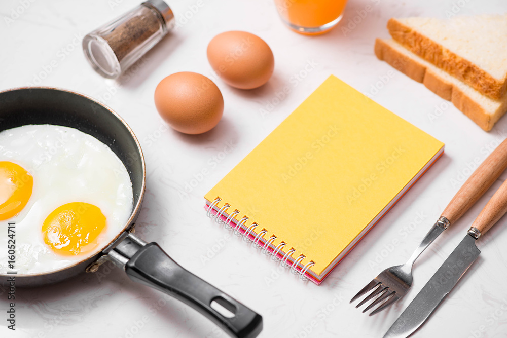 Top view of traditional healthy easy quick breakfast meal made of fried eggs served on a frying pan.
