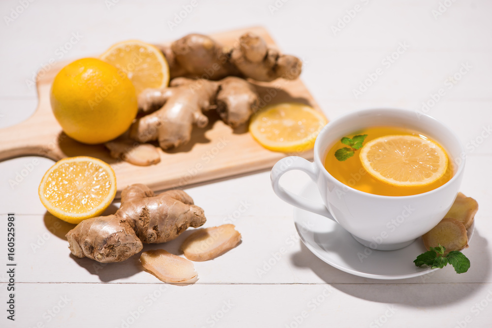 Healthy ginger tea ingredients on a wooden table Healthy ginger tea ingredients on a wooden table