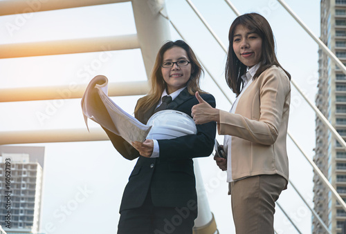 Two businesswomen worker handshaking on construction site