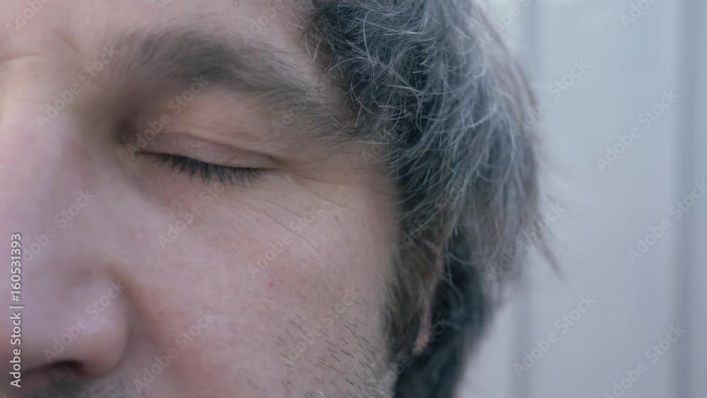 Half of the face of a man looking at the camera. The model is in his 30's. Half of the face of a man looking at the camera. The model is in his 30's.