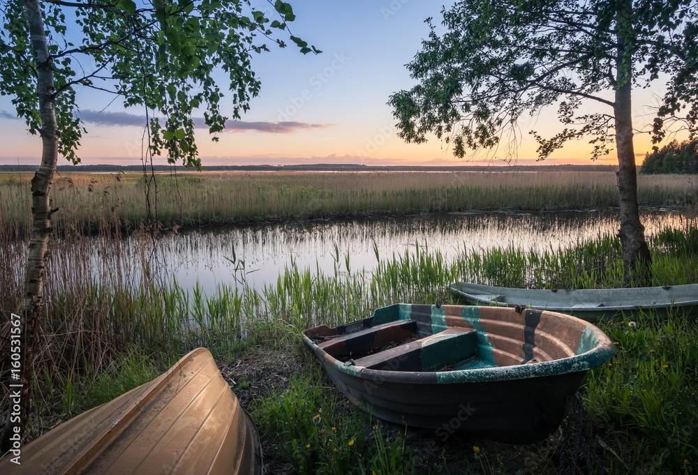 Scenic landscape with rowboats at peaceful summer evening in Hyvinkää, Finland. Scenic landscape with rowboats at peaceful summer evening in Hyvinkää, Finland.