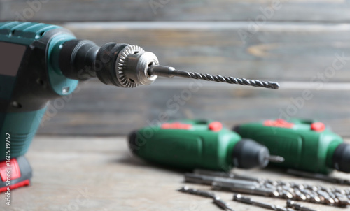 Modern drill on blurred background photo