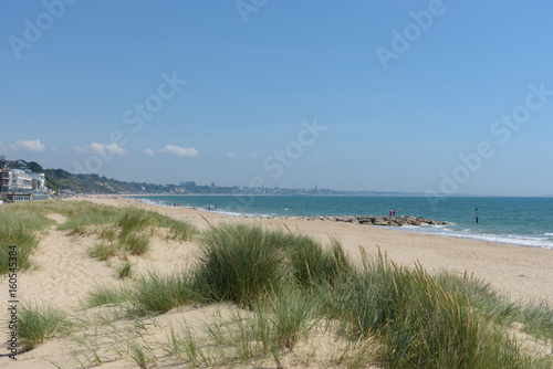 Fototapeta Naklejka Na Ścianę i Meble -  Sandbanks beach with the dunes and Bournemouth in the distance