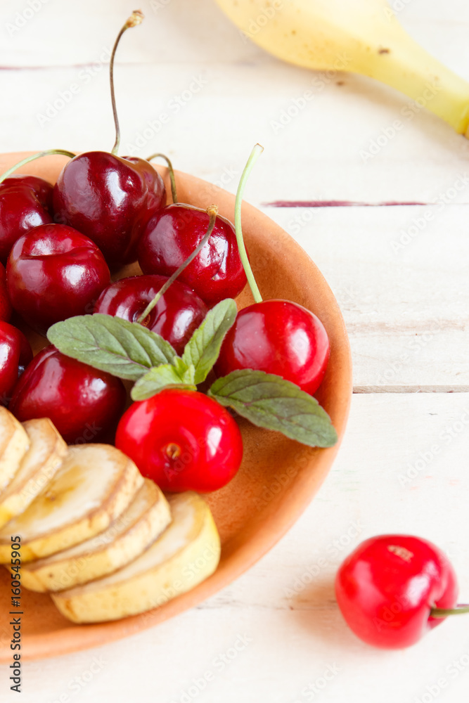 Cherry and sliced banana on a plate. Cherry and sliced banana on a plate.