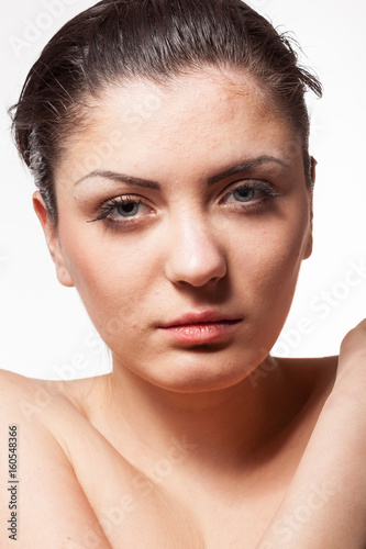 Portrait of gorgeous woman in harsh studio light. Wet hairs. Studio posing