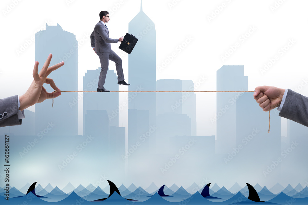 Obraz premium Businessman walking on tight rop in business concept