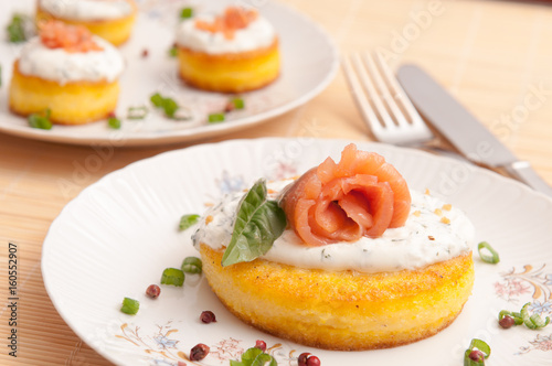 round polenta with cheese onion and salmon