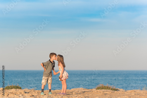 Young boy kissing a girl