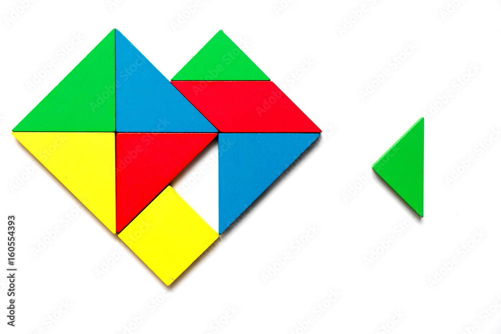 Colorful wooden tangram puzzle in heart shape wait to fulfill with triangle shape on white background