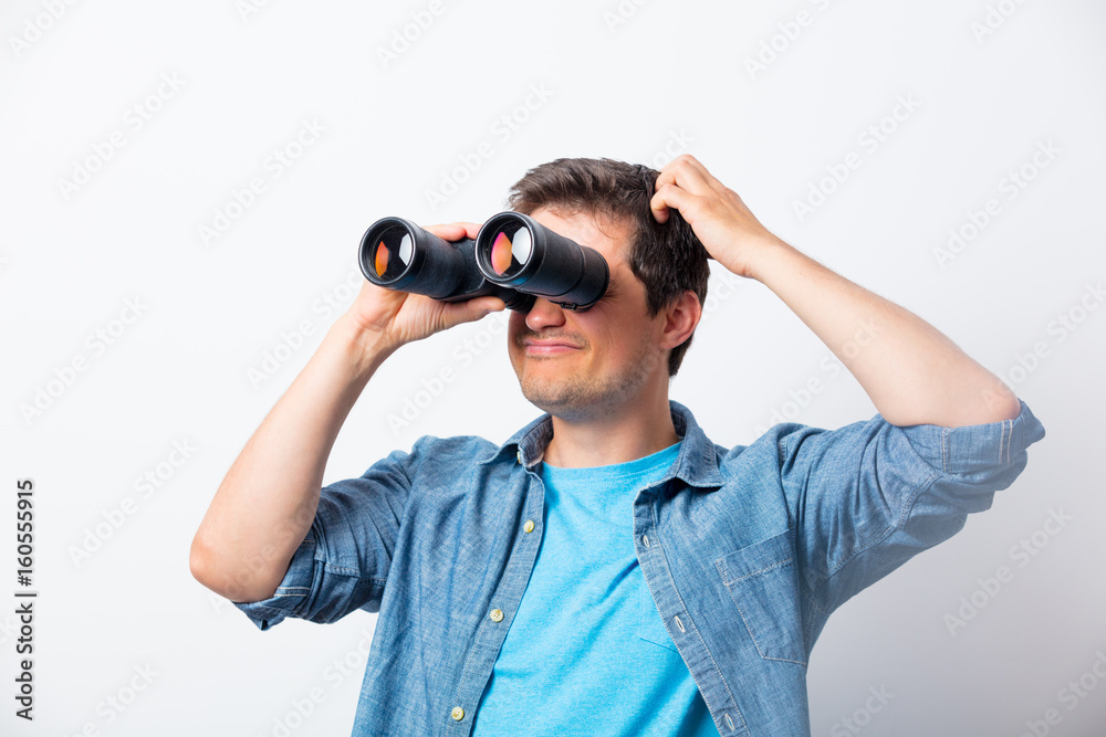 Young man seeking with binocular something