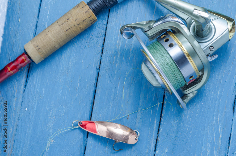 Spinning, reel, fishing lure yellow-red. The bait and the tool of a fisherman. Spinning, reel, fishing lure yellow-red. The bait and the tool of a fisherman.