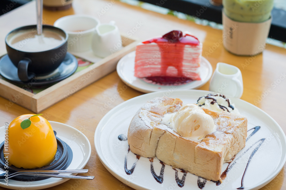 Honey toast with strawberry cake and hot coffee. Honey toast in cozy outdoor cafe.(selective focus, vintage effect) Honey toast with strawberry cake and hot coffee. Honey toast in cozy outdoor cafe.(selective focus, vintage effect)