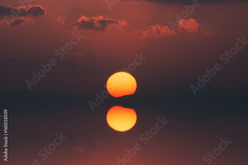 Mirror of Sunset sky on the lake in south of Thailand. © noppharat