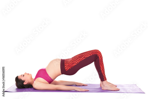 Young beautiful pregnant woman doing yoga exercise isolated on white