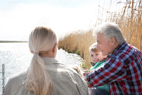 Happy grandparents with lit...