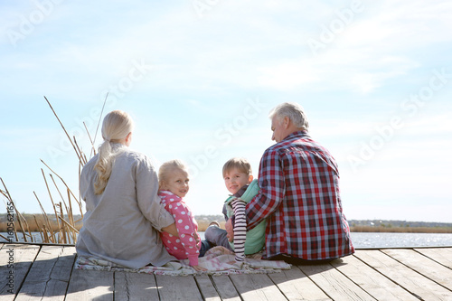 Happy grandparents with lit...