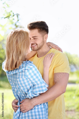 Happy young couple in park ...
