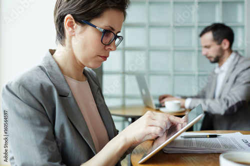 Принти на полотні Portrait of business people working at separate tables in office co-working spac