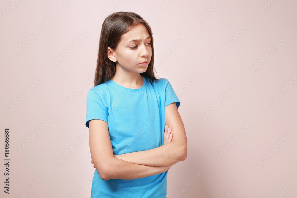 Cute sad girl on color background