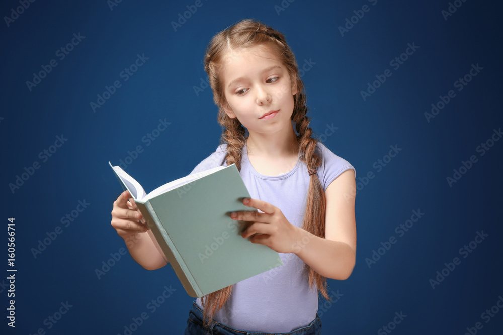 Cute funny girl with book on color background Cute funny girl with book on color background