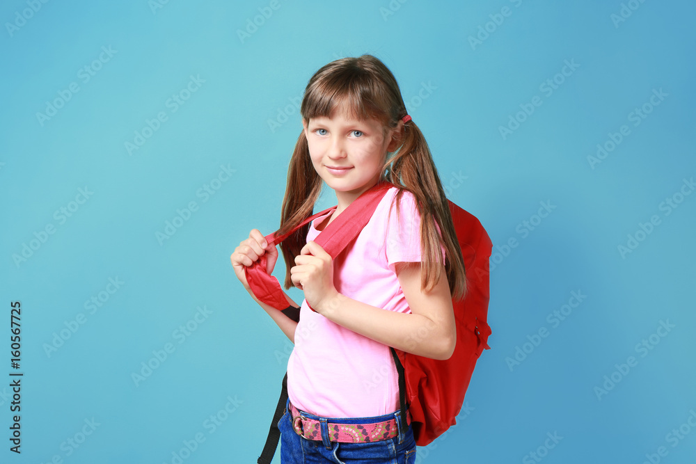 Pretty little girl with schoolbag on color background Pretty little girl with schoolbag on color background