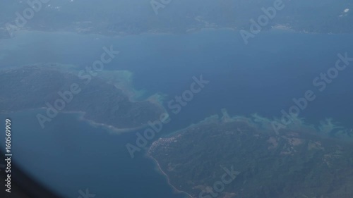 Wallpaper Mural View through an airplane window on the tropical island, ocean, sky and clouds. Aerial view sea, clouds and sky as seen through window of an aircraft. 4K video. Aerial footage. Travel concept. Torontodigital.ca