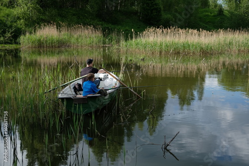 Fototapeta Naklejka Na Ścianę i Meble -  Fishermen in a boat on the lake.