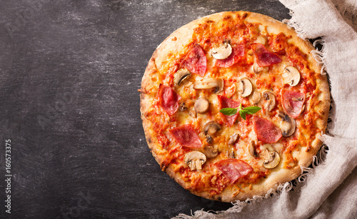 pizza with ham, salami and mushrooms