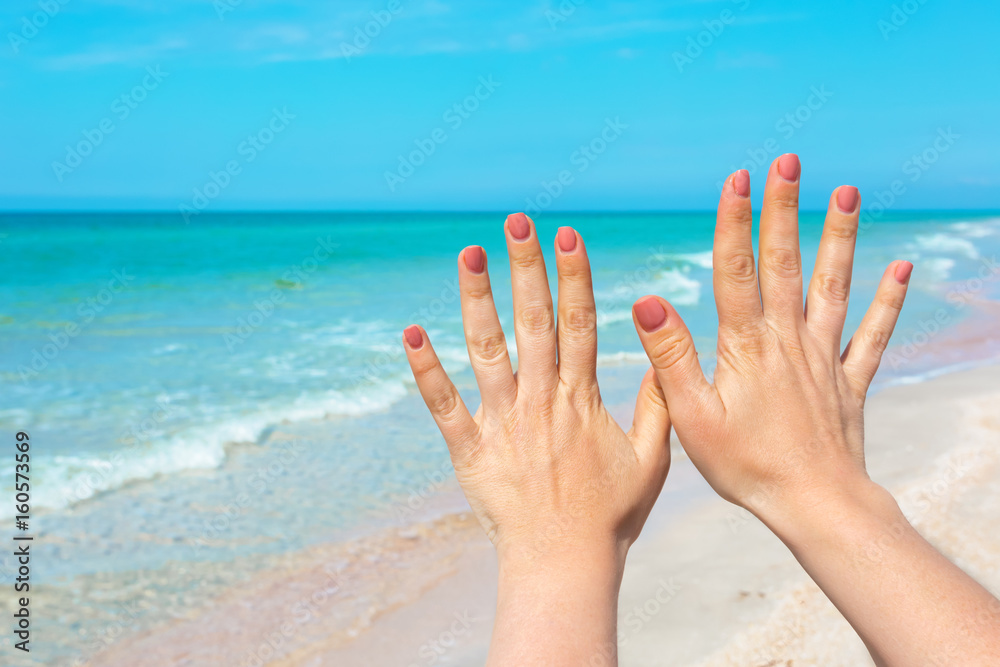 hand sign over blue sea and sky background, summer travel, holiday vacation concept background hand sign over blue sea and sky background, summer travel, holiday vacation concept background