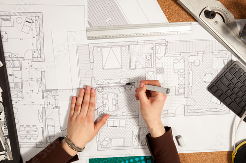 Hands on blueprints on an architect table. Construction and architecture. Project and design