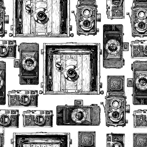 Seamless pattern with photo cameras. Vector illustration in vintage engraved style on white background.  