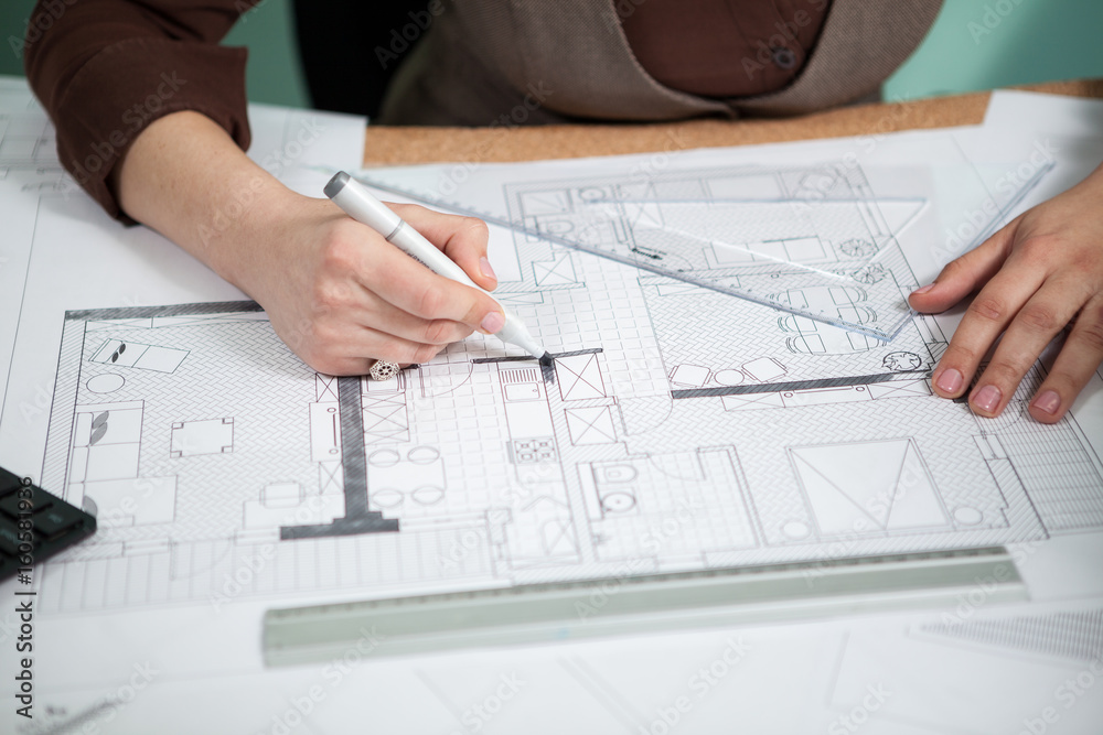 Close up of architect hands working on blueprints. Working on new projects. Architecture and design Close up of architect hands working on blueprints. Working on new projects. Architecture and design