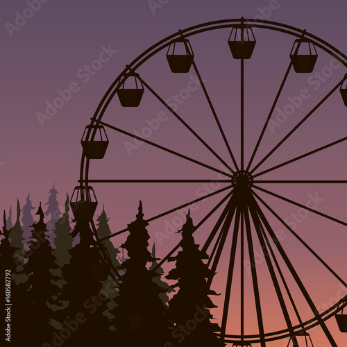 silhouette of Ferris wheel in spuce park on the sunset