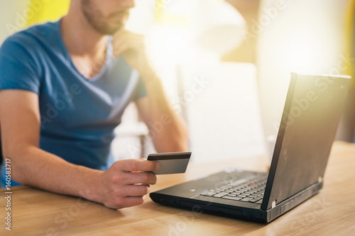 online shopping. Man using his credit card for online shopping