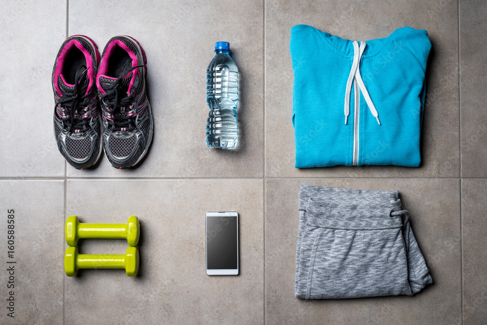 Sport clothing and accessories on gray stone floor Sport clothing and accessories on gray stone floor