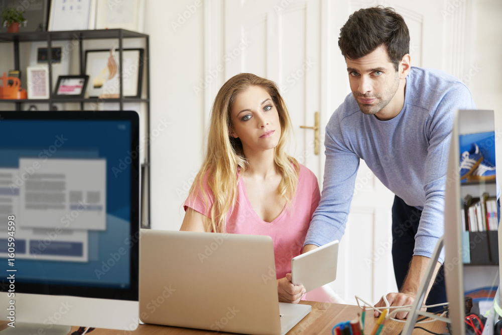 Working as a team. Young creative team working together at office. Working as a team. Young creative team working together at office.