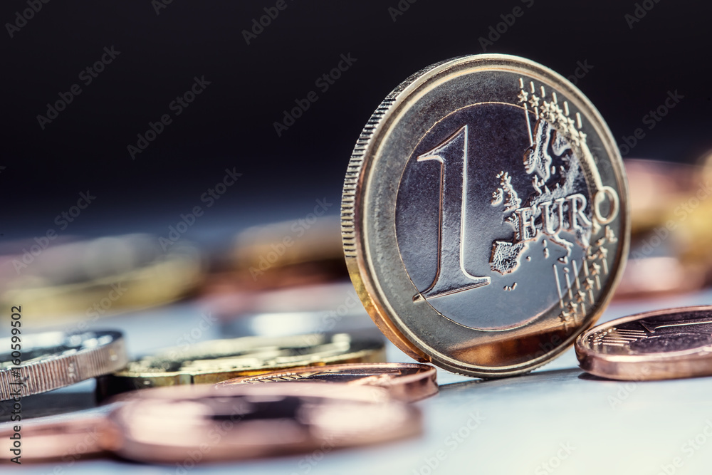 One euro coin on the edge. Euro money currency. Euro coins stacked on each other in different positions. - obrazy, fototapety, plakaty 