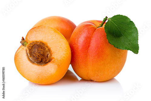 Ripe apricot fruits with with green leaf and slice isolated photo