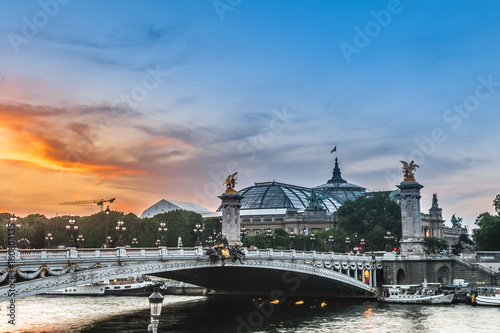Sunset with Alexander III bridge, Great Palace and the Seine river in Paris, France