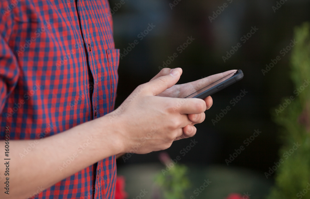 Man's hands using mobile smartphone outdoors Man's hands using mobile smartphone outdoors