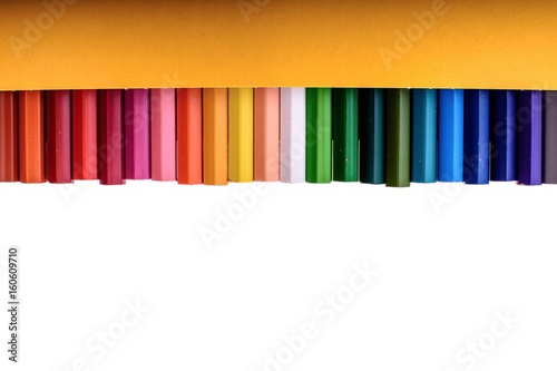Many colored pencils isolated on white background, place for text